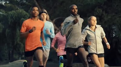 a group of people running in a park