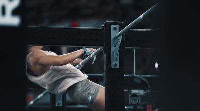 a man performing a pull - ups on a pull - up bar