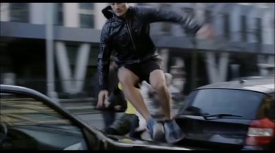 a man riding a skateboard down the side of a road