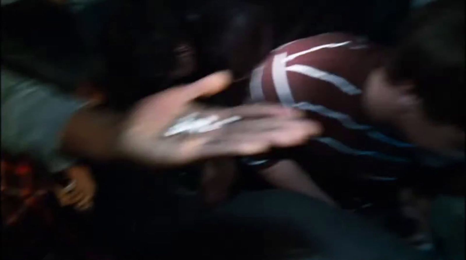 a blurry photo of a person holding a football