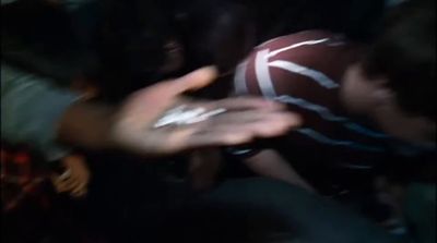 a blurry photo of a person holding a football