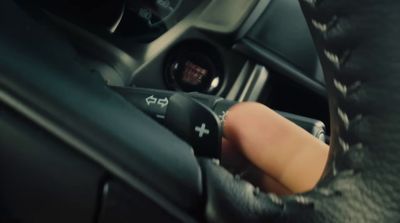 a person holding a remote control in a car