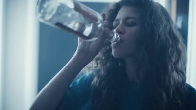 a woman drinking water from a bottle