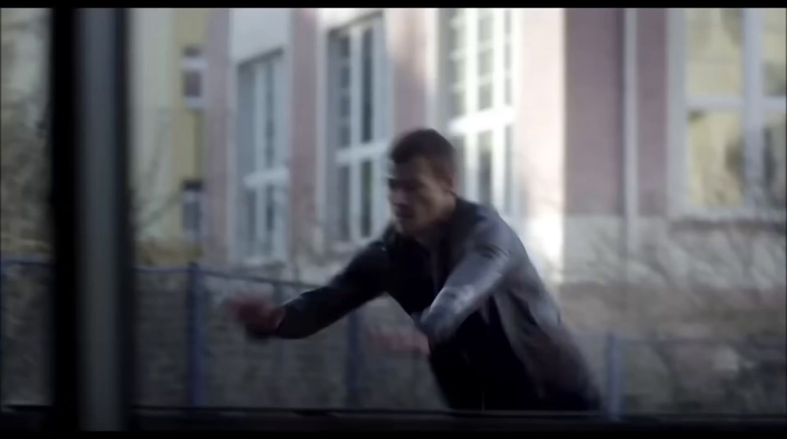 a blurry image of a man in a black jacket