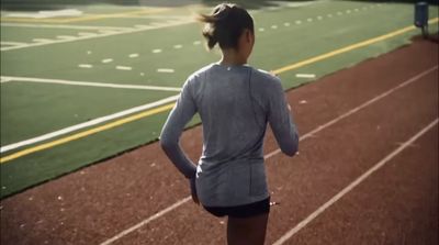 a woman running on a running track