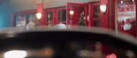 a blurry photo of a restaurant with red booths