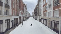 a person riding skis down a snow covered street