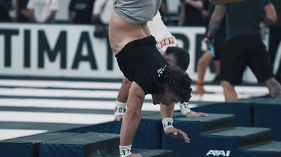 a man doing a handstand on top of a box