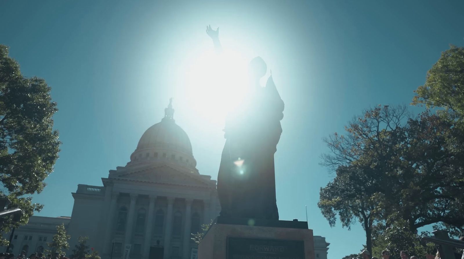 the sun shines brightly over the statue of liberty