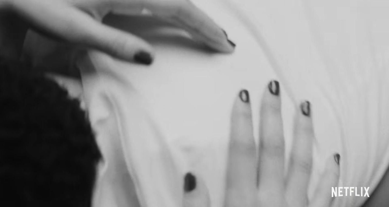 a black and white photo of a woman's hands and nails