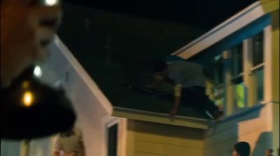 a group of people standing outside of a house at night