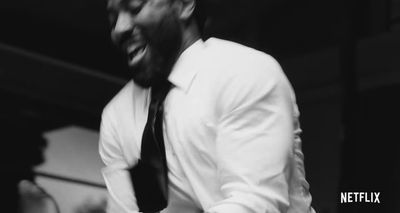 a black and white photo of a man laughing