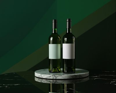 two bottles of wine sitting on a marble table