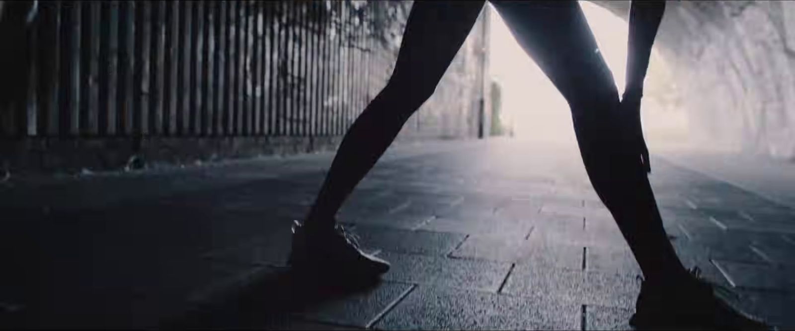 a woman in high heels walking down a street