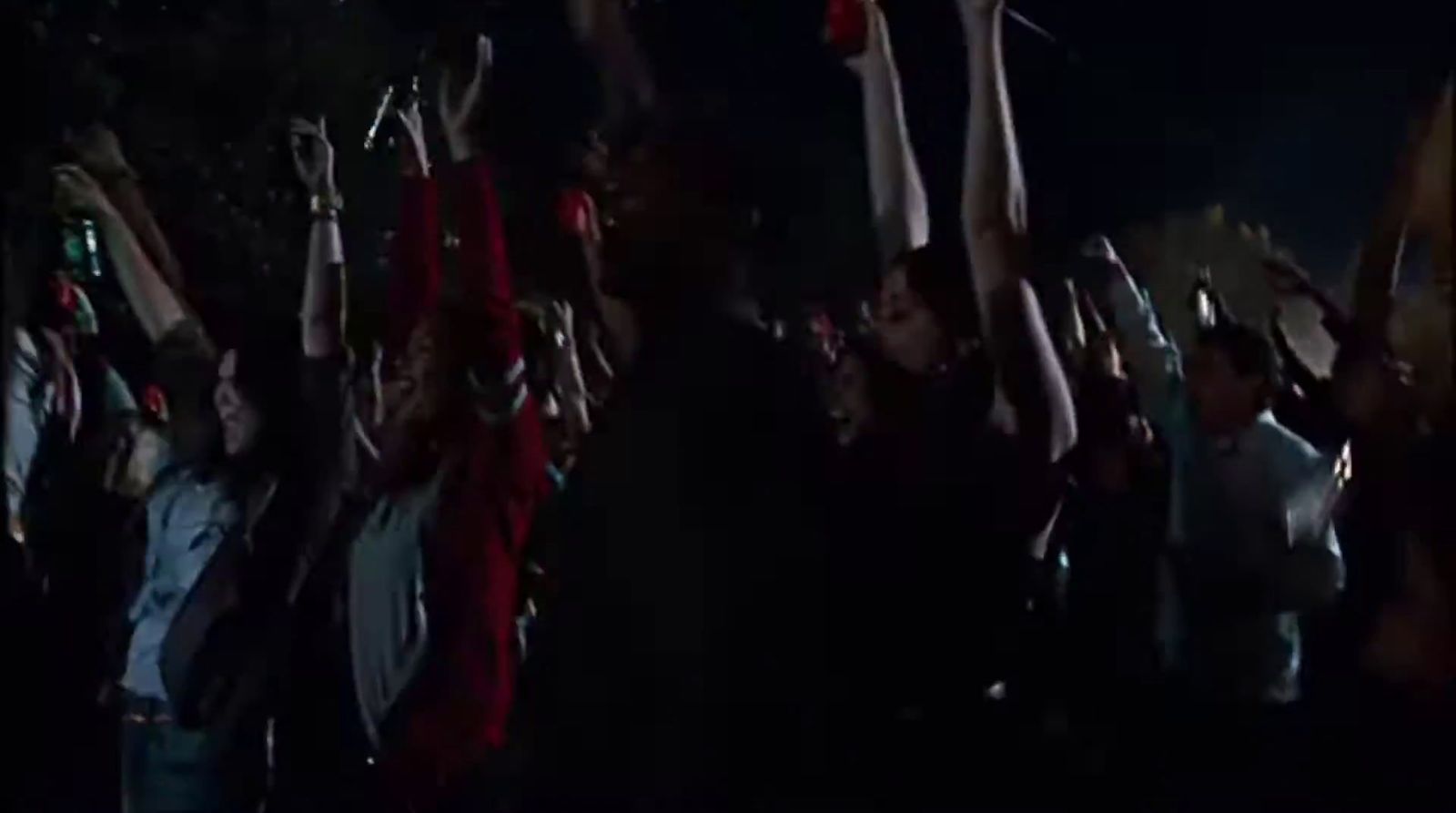 a group of people holding up their hands in the air