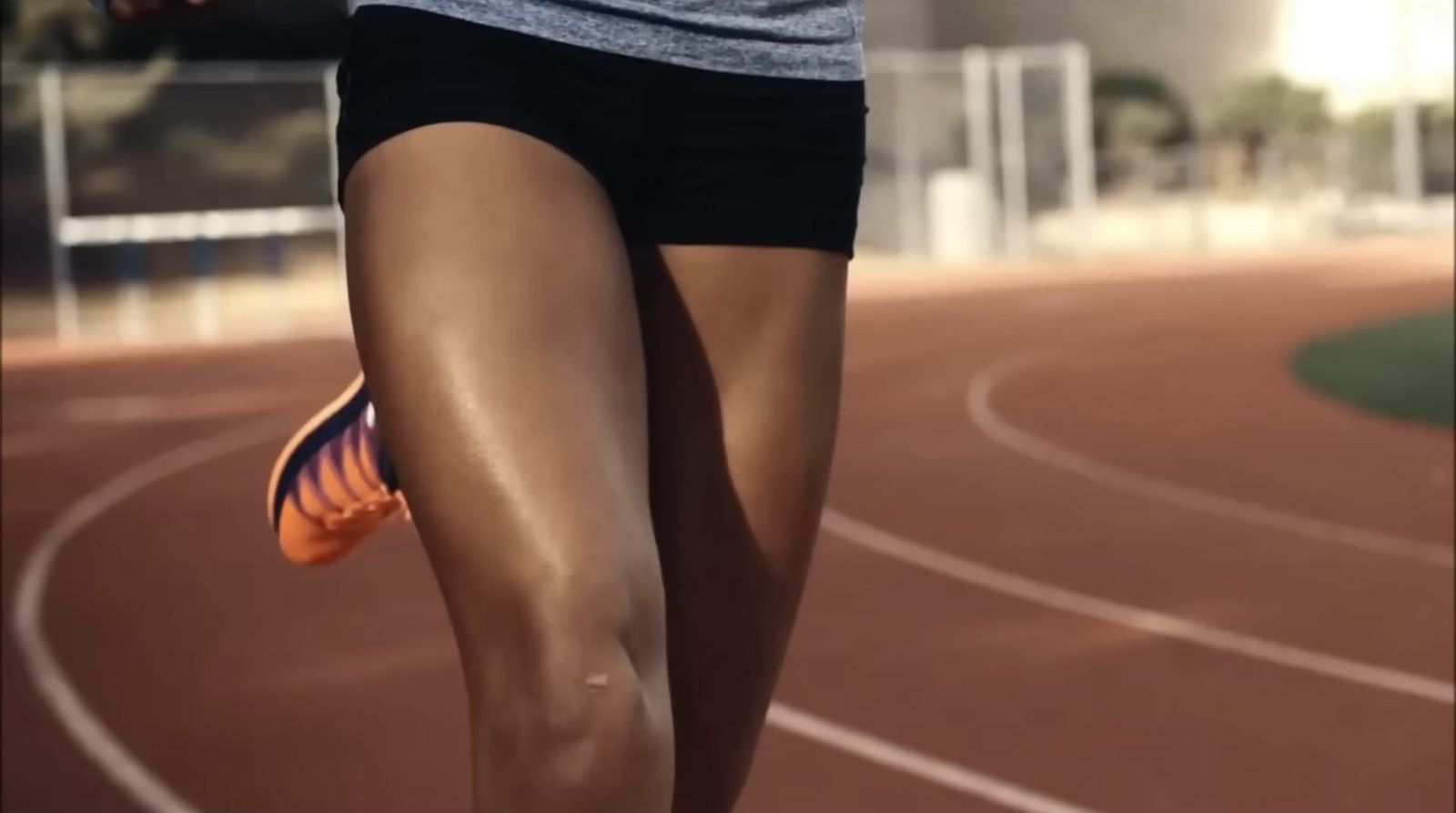 a close up of a person running on a track