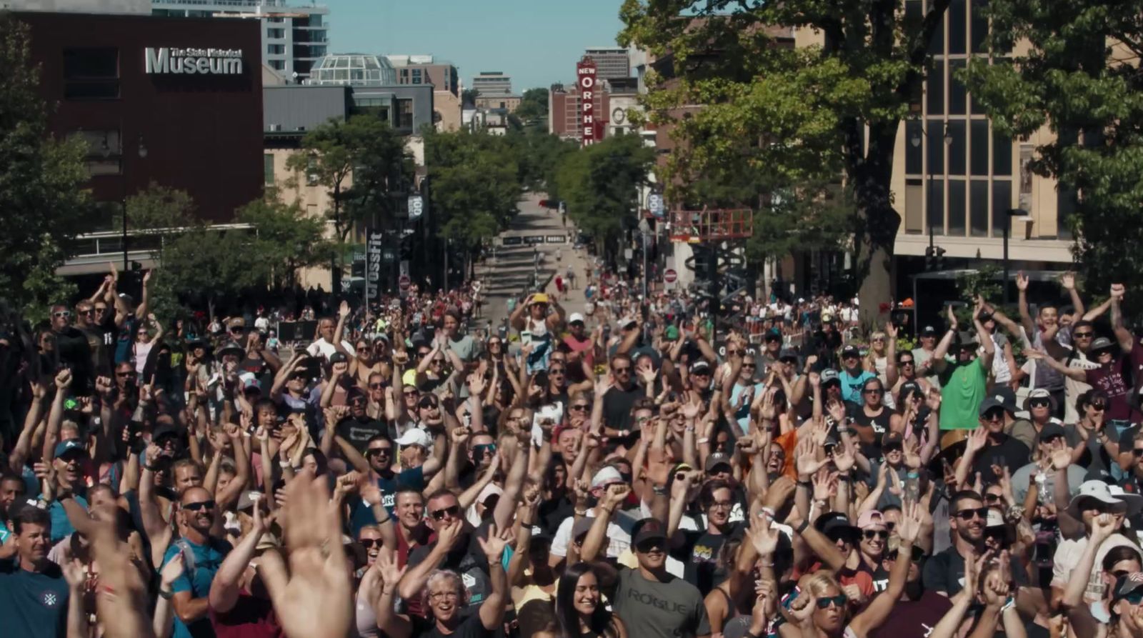 a large group of people standing in the middle of a street