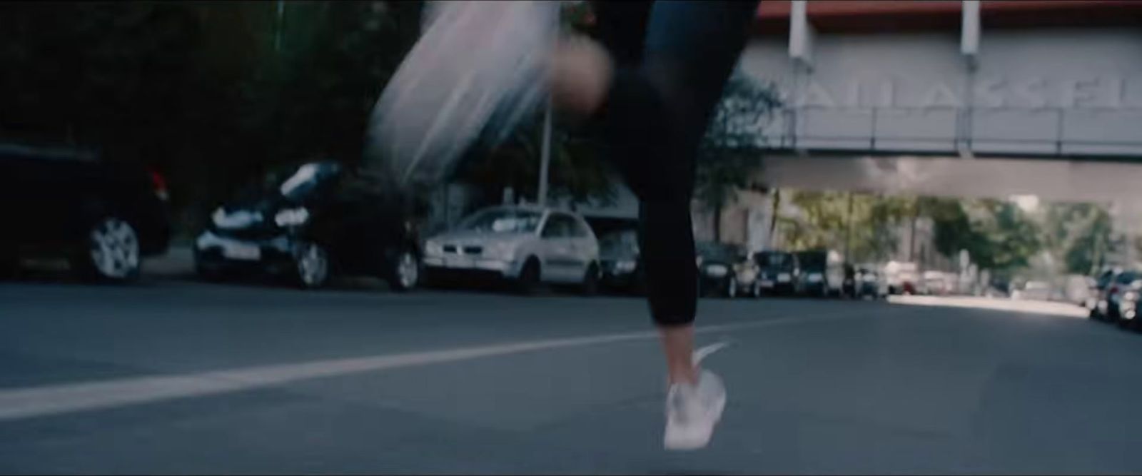 a person is walking down the street with their feet in the air