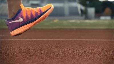 a close up of a person running on a track