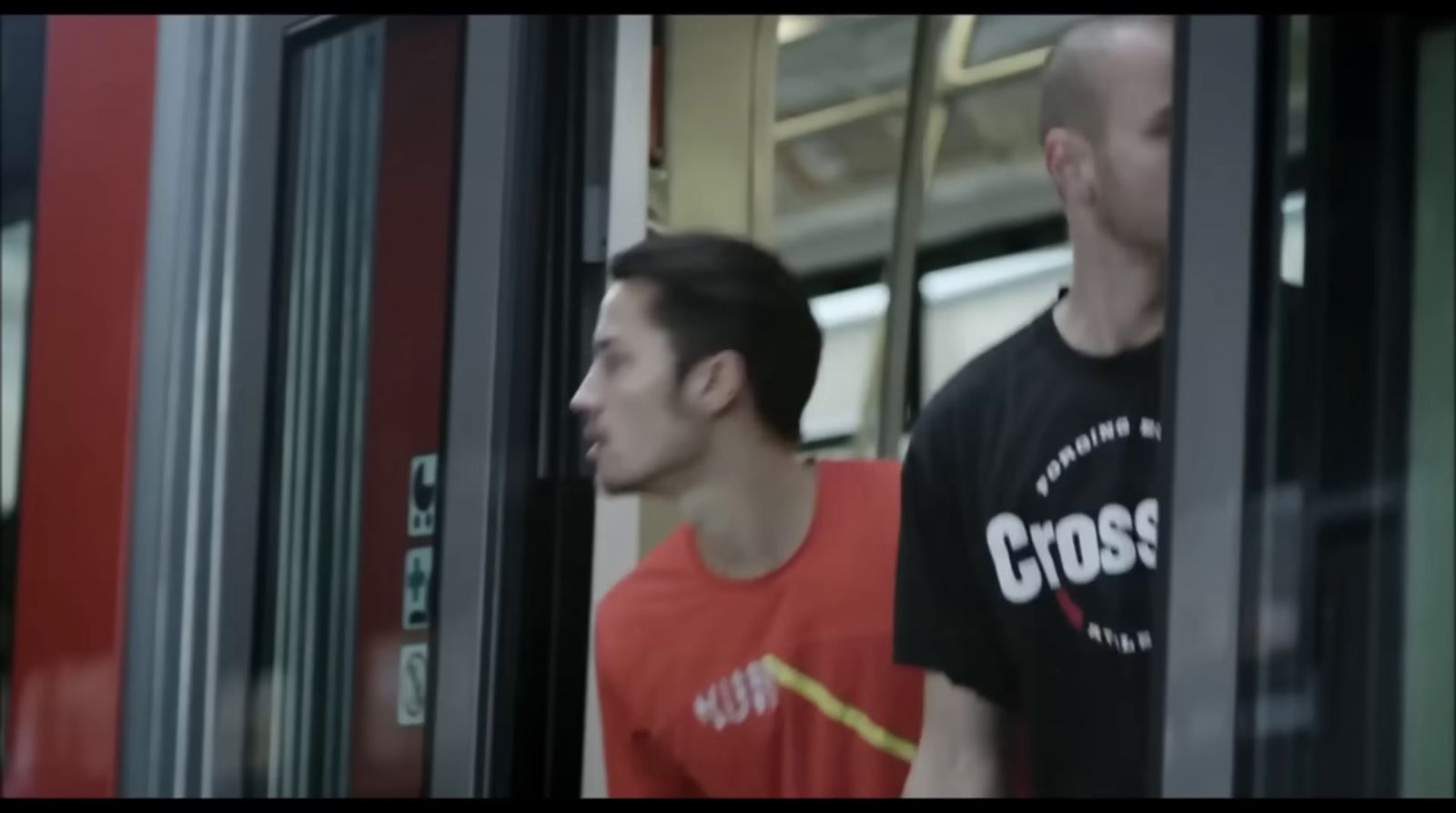 a man standing next to another man on a train