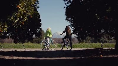 a couple of people riding bikes down a road