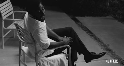 a man sitting on top of a white chair