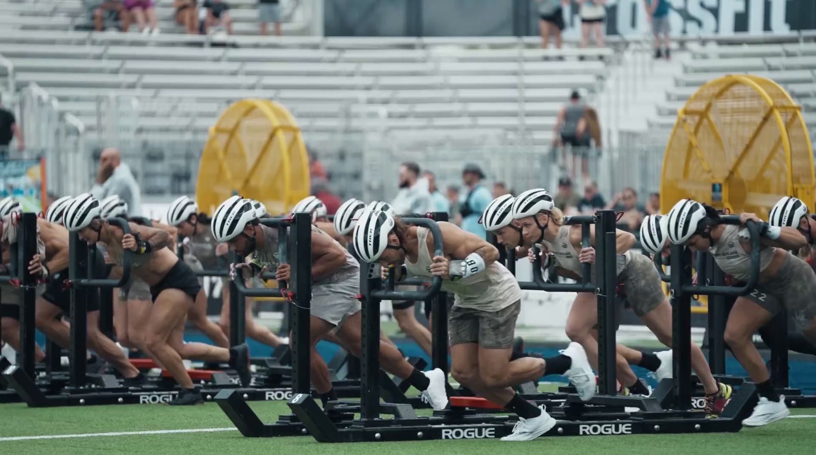 a group of people doing squats on a field