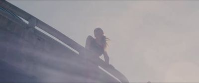 a woman standing on top of a wooden structure