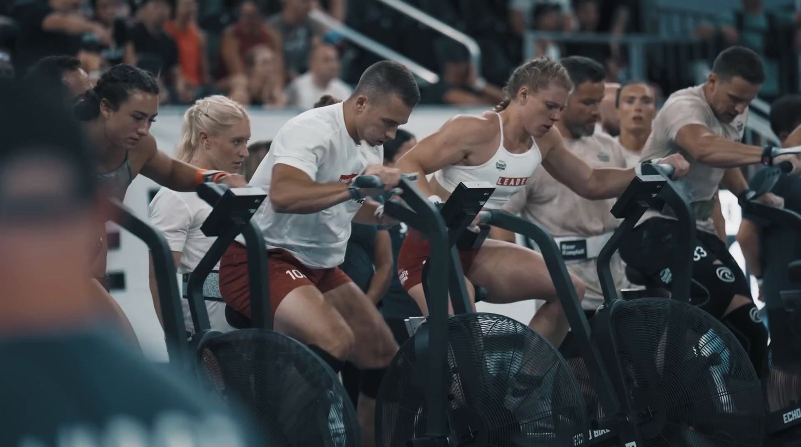 a group of people riding stationary bikes in a gym