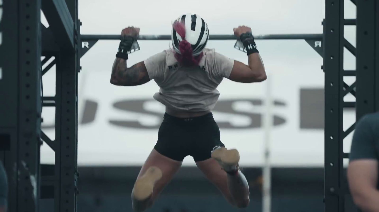 a man doing a pull up on a metal bar