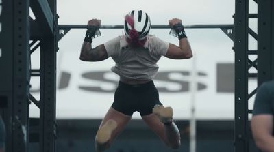 a man doing a pull up on a metal bar