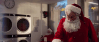 a man dressed as santa claus in a kitchen