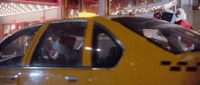 a taxi cab with a santa clause sitting on top of it