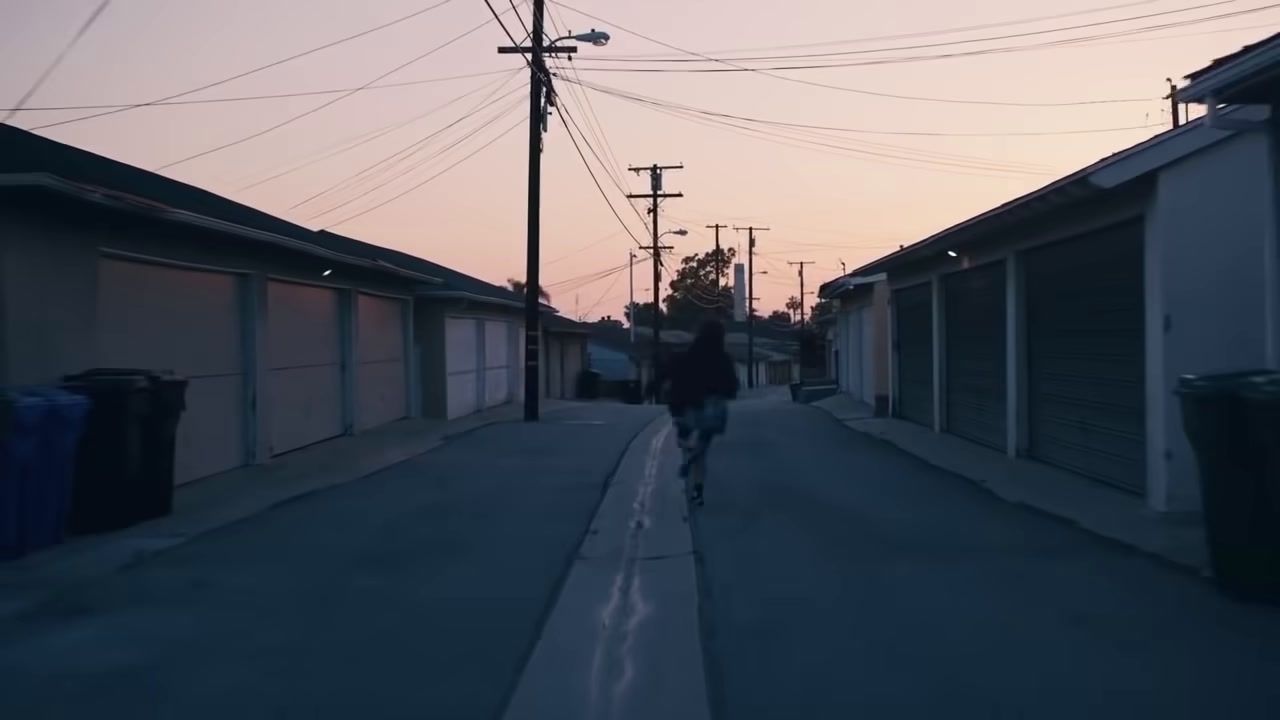 a person riding a skateboard down a street