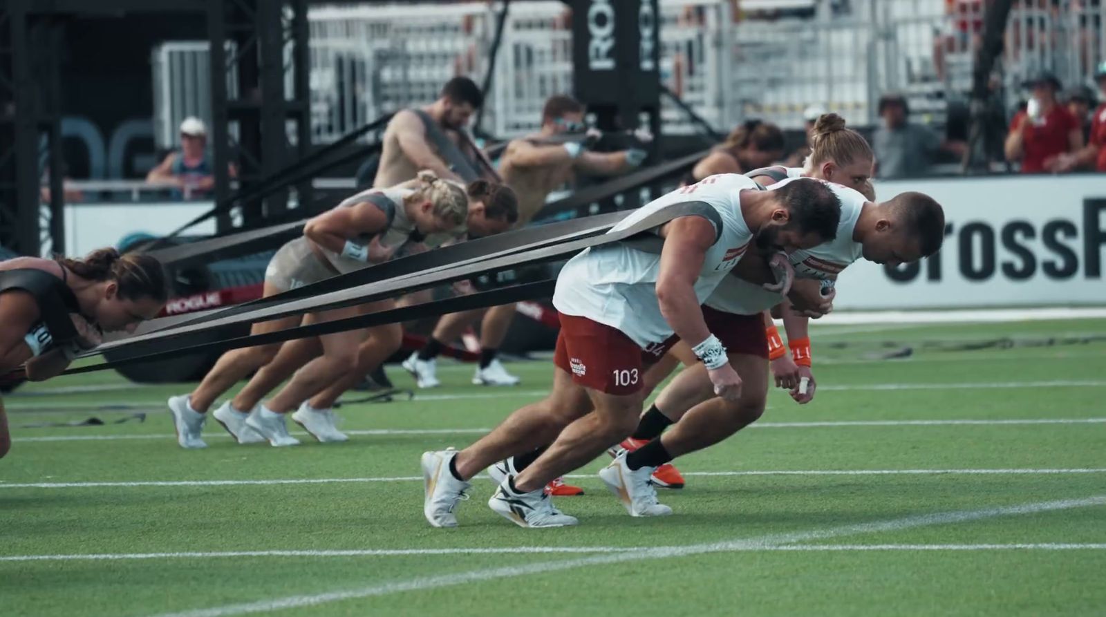 a group of people on a field playing field hockey