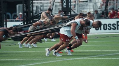 a group of people on a field playing field hockey