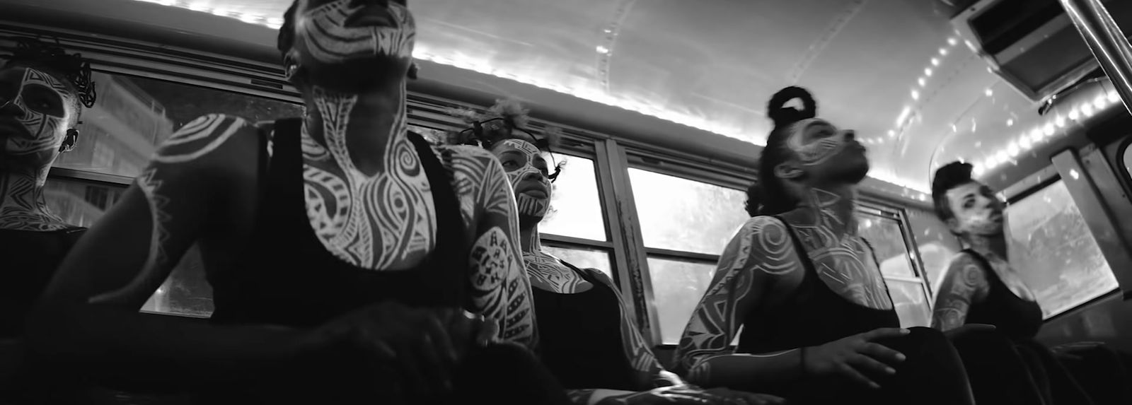 a black and white photo of a group of people on a bus