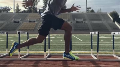 a man running on a track in a stadium