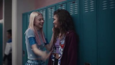 two girls standing next to each other near lockers