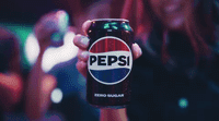 a woman holding up a can of pepsi