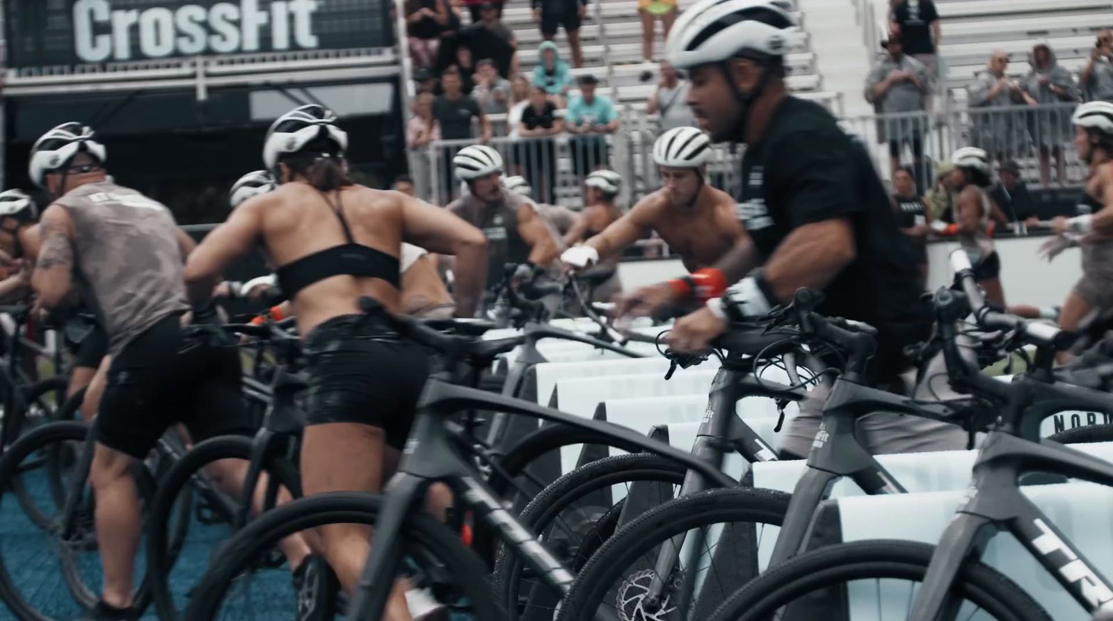 a group of people riding bikes down a street