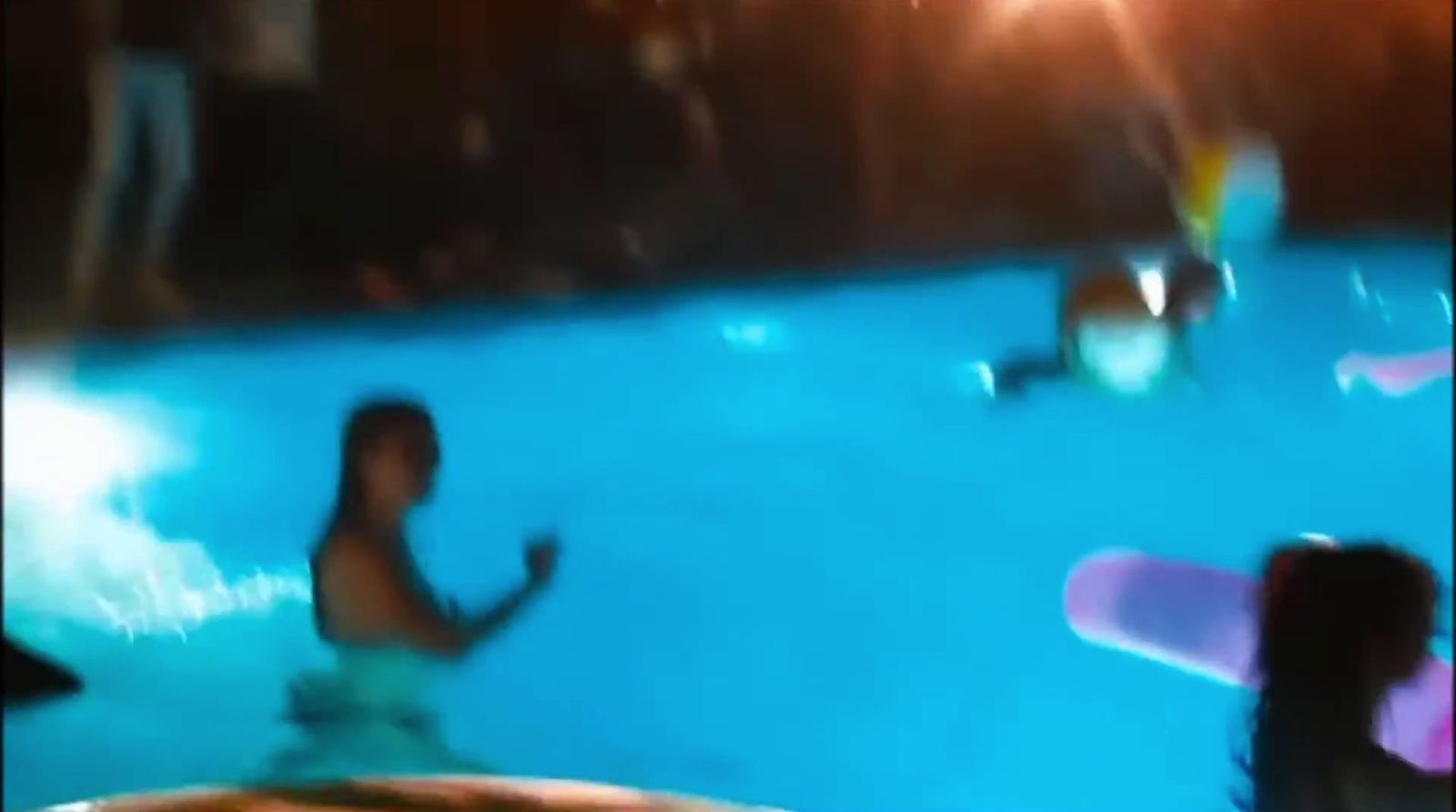 a blurry photo of a man in a swimming pool