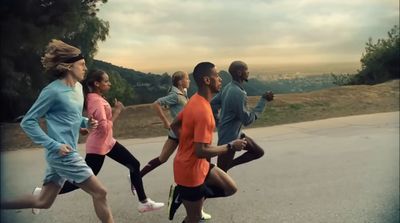 a group of people running down a road