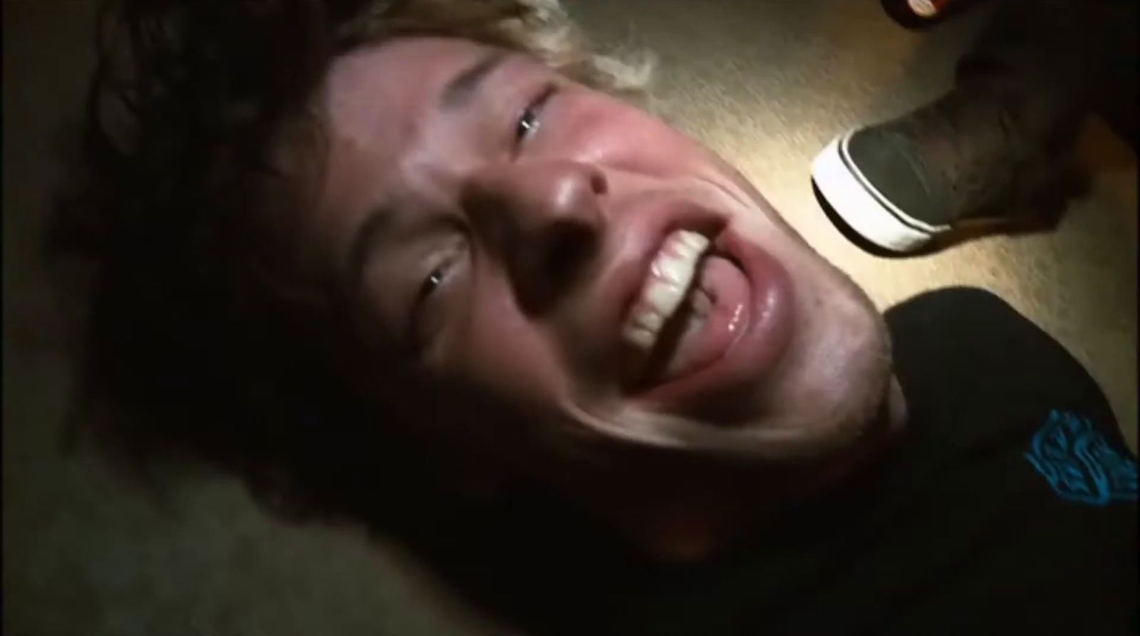 a man laying on the floor with his mouth open