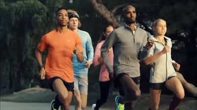 a group of people running down a street