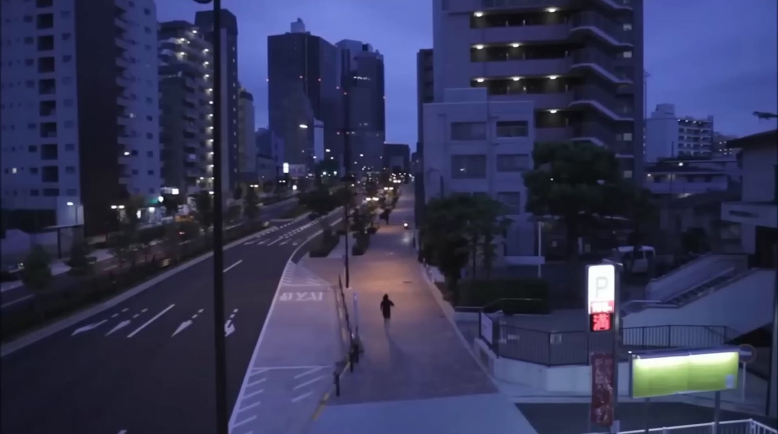 a person walking down a street at night