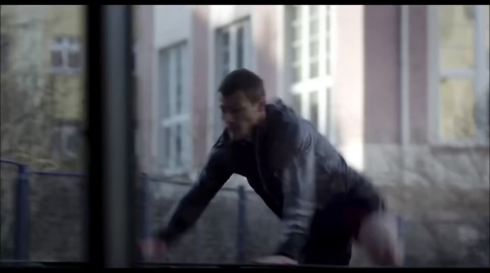 a blurry image of a man in a black jacket