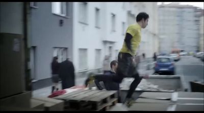 a young man riding a skateboard down a wooden ramp