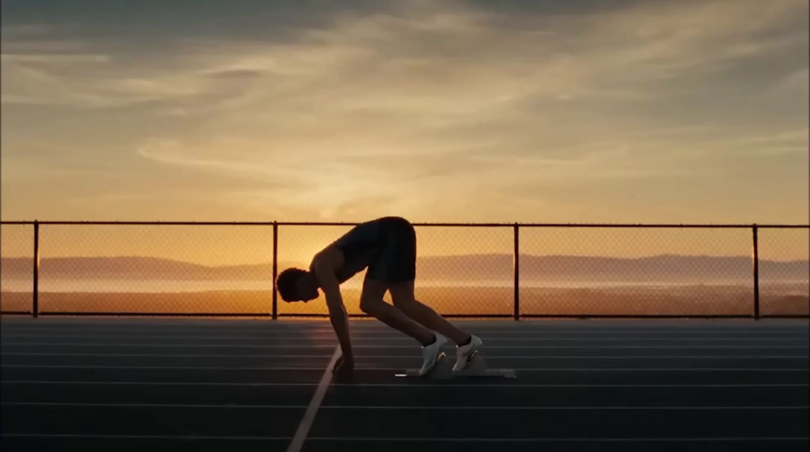 a person bending over on a tennis court