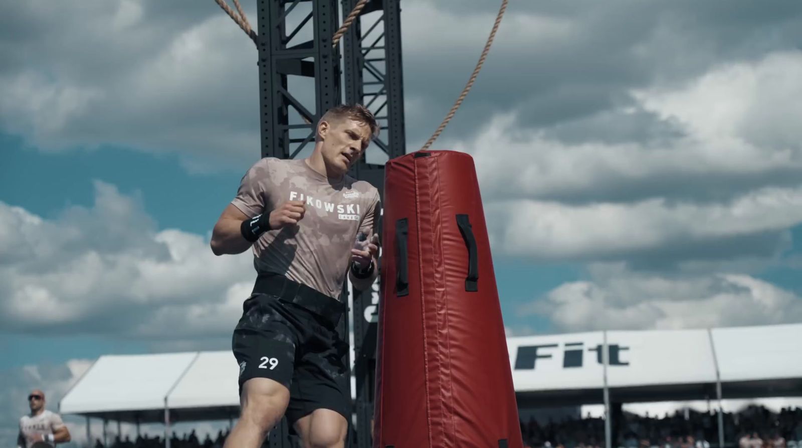 a man running past a red punching bag